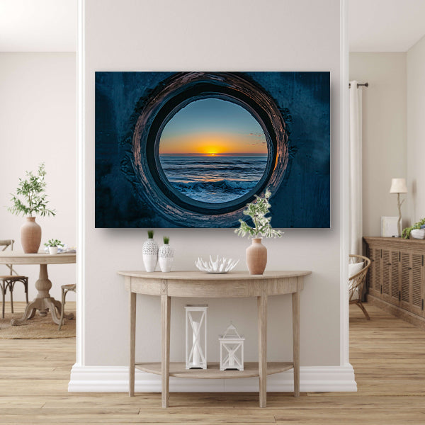 Zonsondergang door een ronde opening aan zee poster