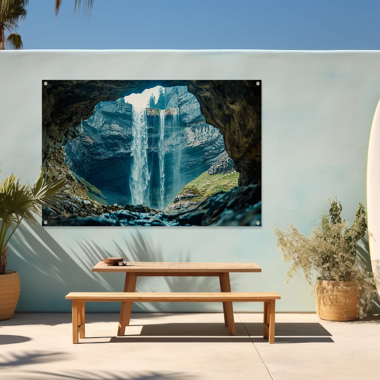 Waterfall seen through rocky cave opening tuinposter