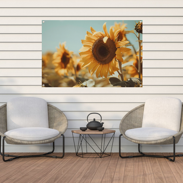 Zonovergoten zonnebloemveld onder een helderblauwe hemel tuinposter
