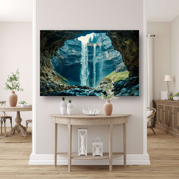 Waterfall seen through rocky cave opening canvas