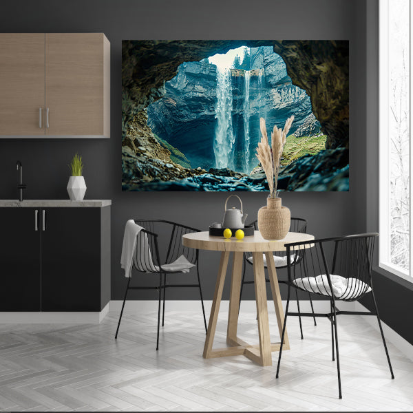 Waterfall seen through rocky cave opening canvas
