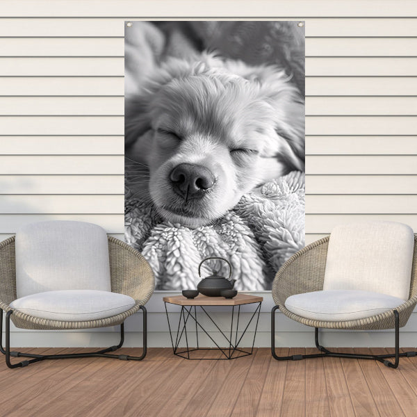 Zwart-wit foto van slapende puppy op deken tuinposter